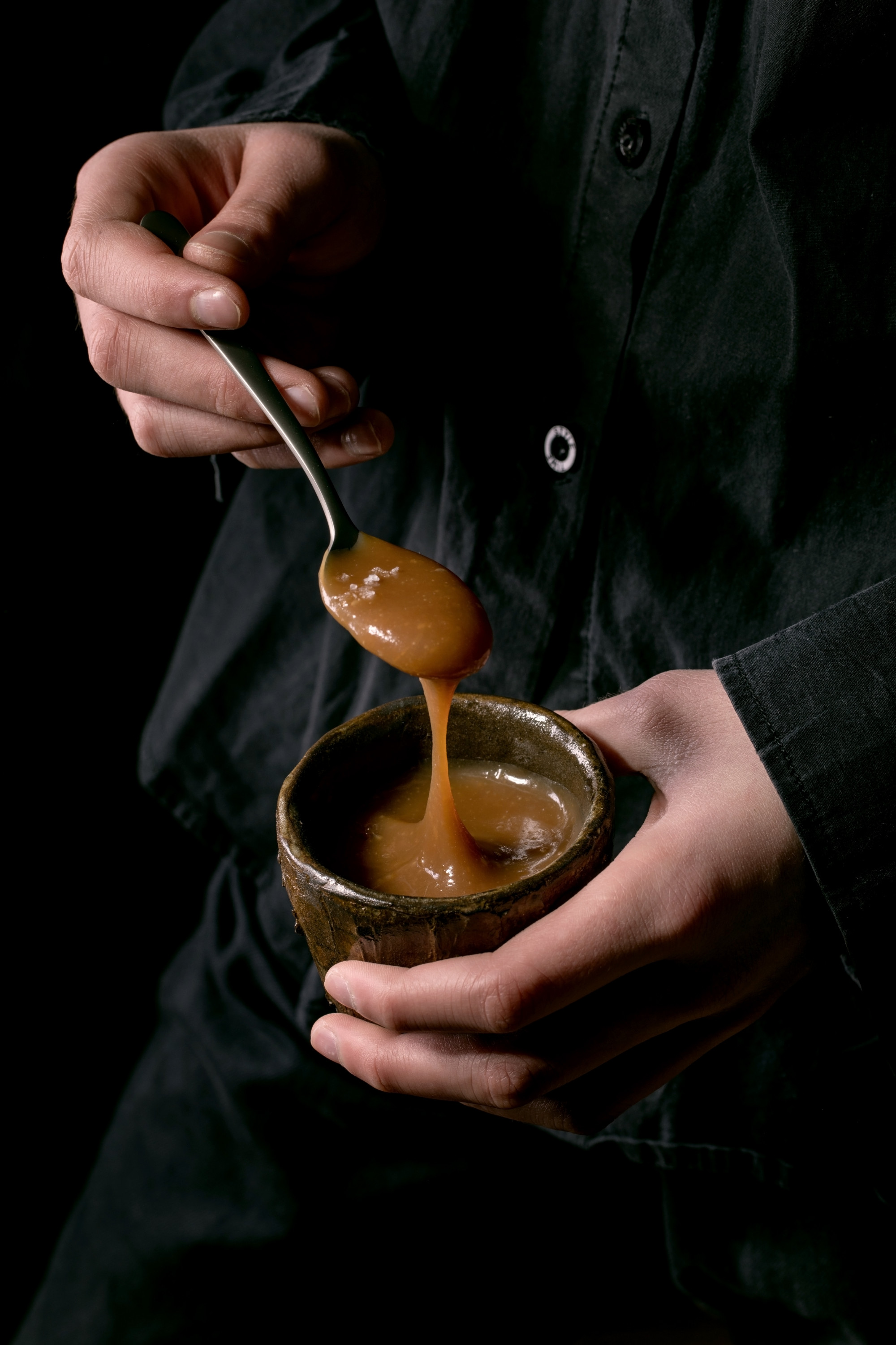 Chef finishing a sauce